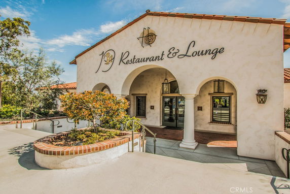 Front view of a building with arched entrances and a sign reading 'Restaurant & Lounge'.