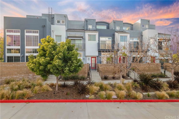 Front view of a contemporary multi-story townhouse building.