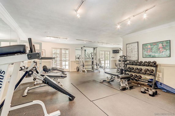 Indoor gym area with exercise equipment and weights