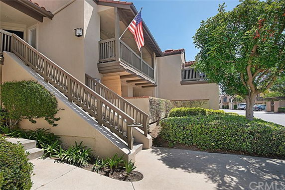 Front view of a building with a staircase and balconies.