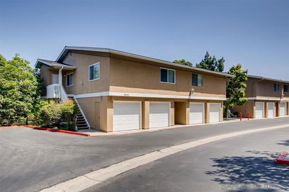 Front view of a two-story building with multiple garages.