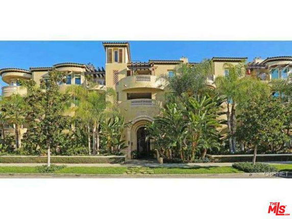 Front view of a multi-story luxury building with balconies and ornate architecture.