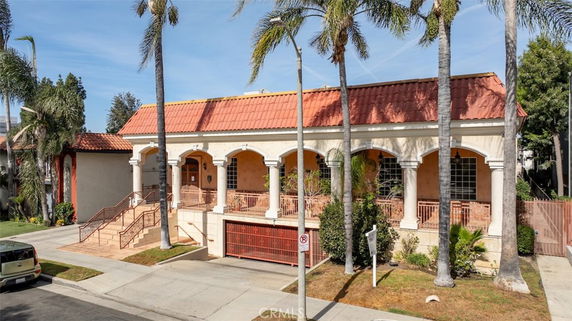 Front view of a building with a terracotta roof and columns.