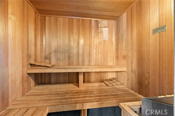 Interior view of a wooden sauna room with benches.