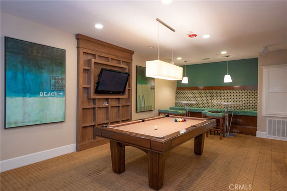 Indoor recreational area with a pool table and wall-mounted TV.