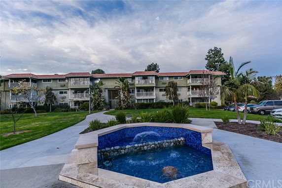 Front view of a multi-story residential building with balconies.
