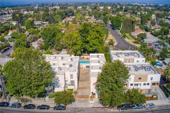 Aerial view of a residential neighborhood with multi-story buildings and tree-lined streets.