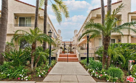 Front view of two-story residential buildings with a walkway in between.
