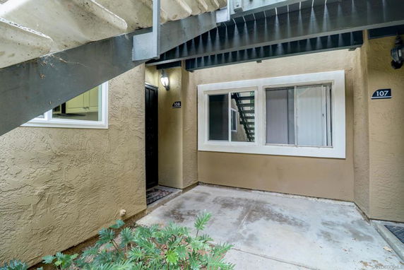 Front view of an apartment entrance with stairs above.