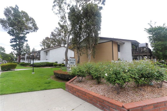 Front view of a residential complex with multiple units and landscaped surroundings.