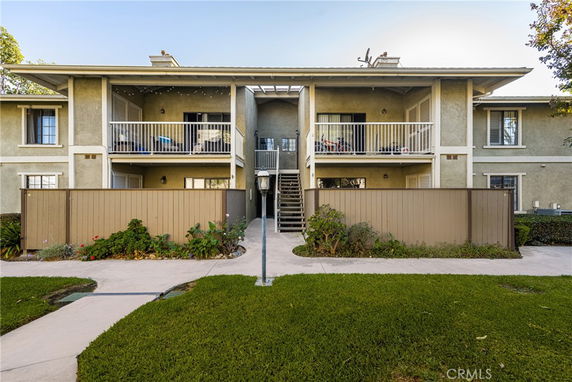 Front view of a two-story apartment building with balconies.