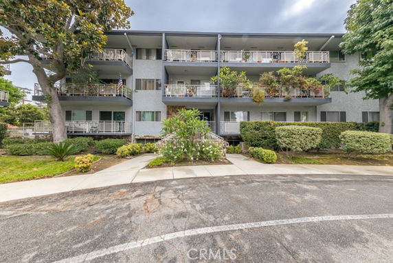 Front view of a multi-story building with balconies.