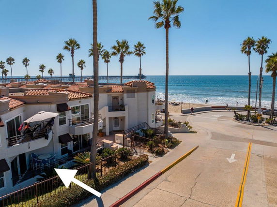 View of a beachfront building with ocean in the background.