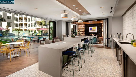 Indoor recreation area with bar seating and lounge space.