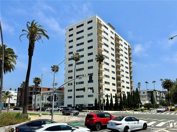 Front view of a multi-story apartment building with balconies.