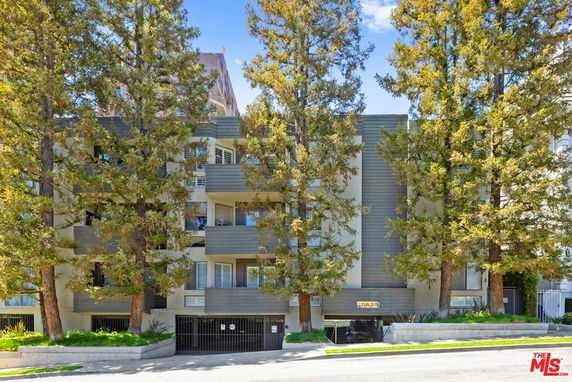 Front view of a multi-story residential building with balconies.
