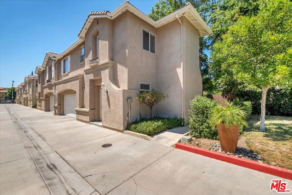 Front view of a two-story townhouse with garage.