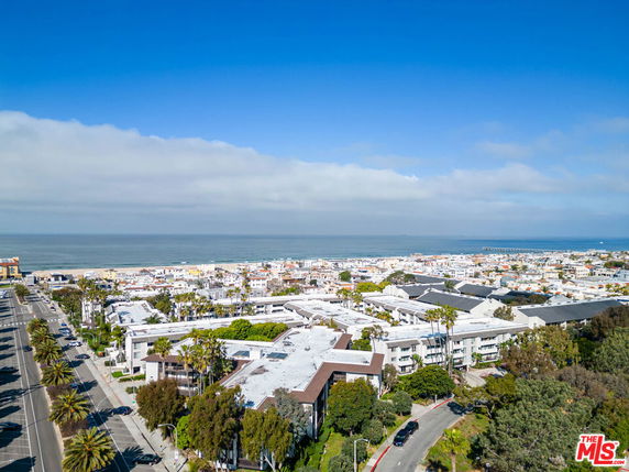 Panoramic view of coastal city buildings and ocean in the background.