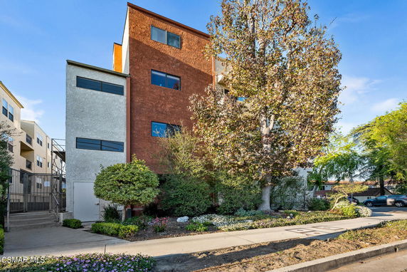 Front view of a multi-story building with modern design and contrasting colors.