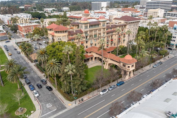 Elevated view of a large historic building with red-tiled roofs and ornate architectural details.