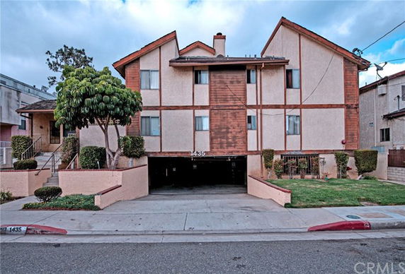 Front view of a multi-story residential building with a garage.