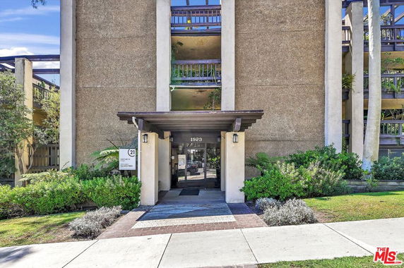 Front view of a multi-story building entrance with modern design.