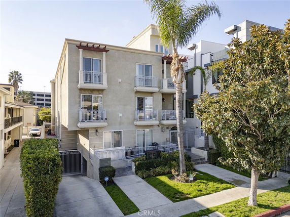 Front view of a multi-story residential building with balconies.