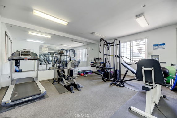 Indoor gym area with exercise equipment like treadmills and weight machines.