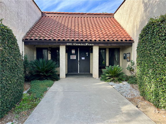 Front view of a building with a tiled roof and entrance.