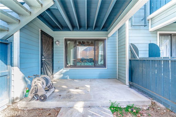 Exterior view of a building with a blue facade and covered porch area.