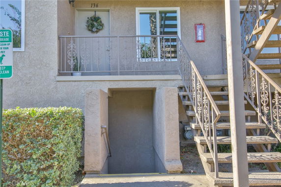 Front view of a multi-level building with a staircase and entrance.