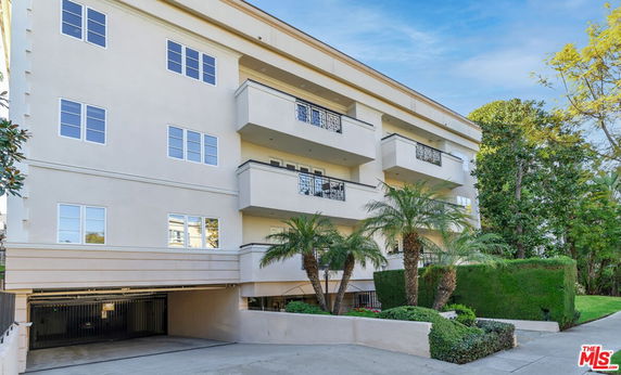 Front view of a multi-story residential building with balconies.