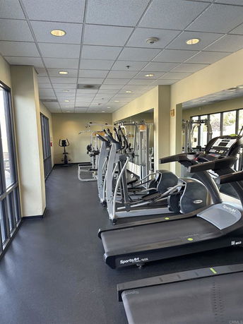 Indoor gym area equipped with treadmills and exercise machines.