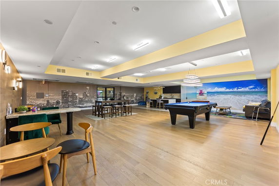 Interior of a recreation room with a pool table and seating area.