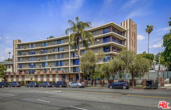 Front view of a multi-story residential building with balconies.