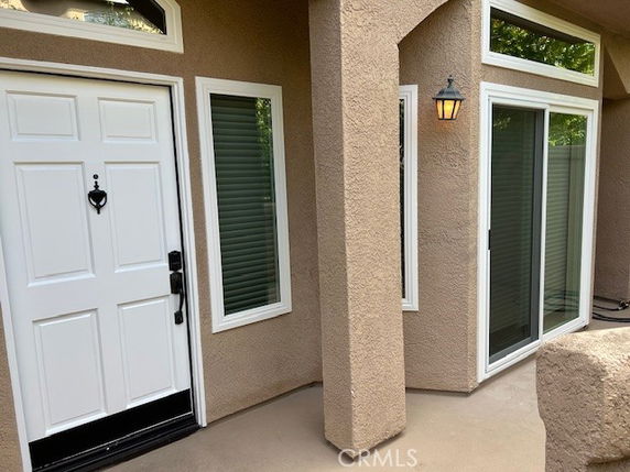Front view of a house with a white door and windows.