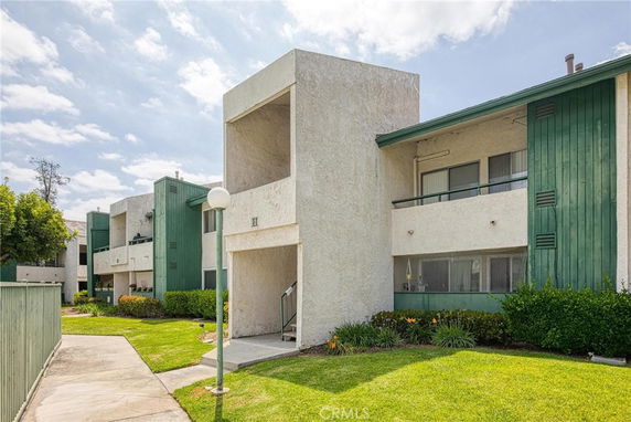 Front view of a multi-story residential building with balconies.