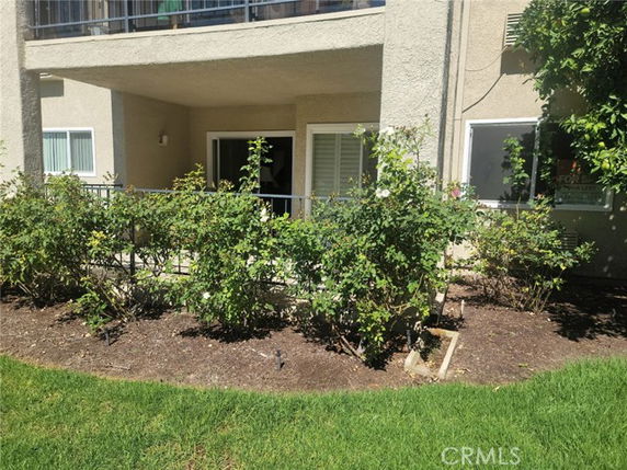 Front view of a building with a small patio area and garden.