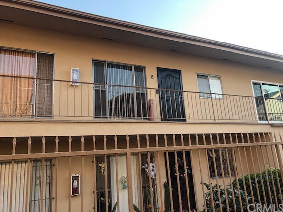 Front view of a two-story apartment building with balconies.