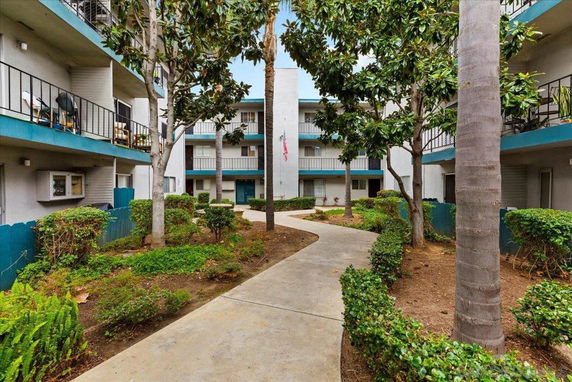 Courtyard view of a multi-story apartment complex with balconies.