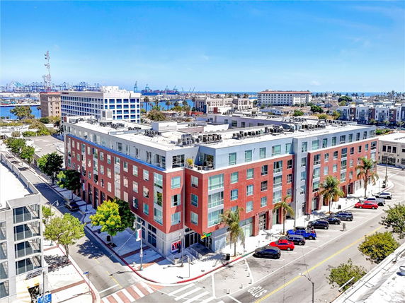 Front view of a multi-story brick building with large windows and a corner entrance.