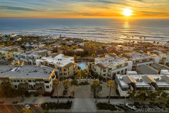 Aerial view of a coastal residential area at sunset.