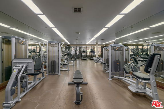 Interior view of a gym with various exercise equipment.