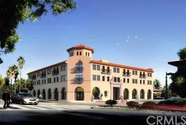 Front view of a multi-story building with arches and balconies.