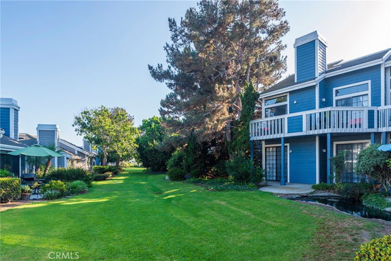 Front view of a two-story house with a balcony and blue siding.