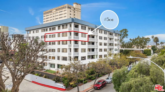 Front view of a multi-story apartment building with designated unit number.