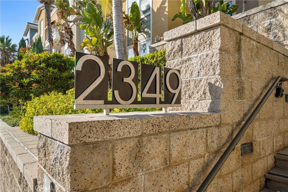 Front view of a building with stone walls and address number 2349 displayed.
