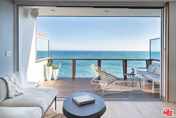 Panoramic view from a balcony overlooking the ocean.