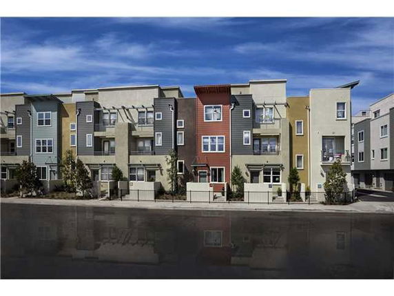 Front view of a modern multi-story residential building with colorful facades.