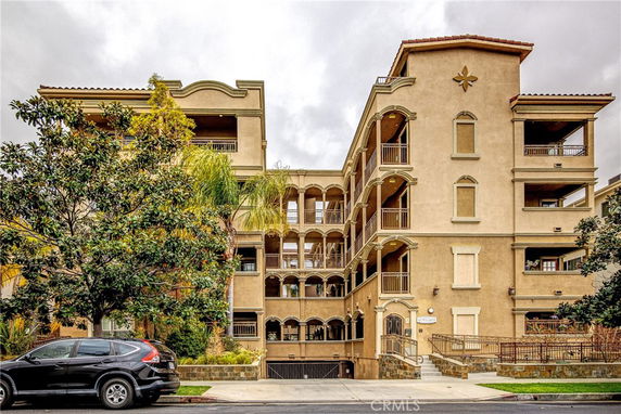Front view of a multi-story residential building with balconies.